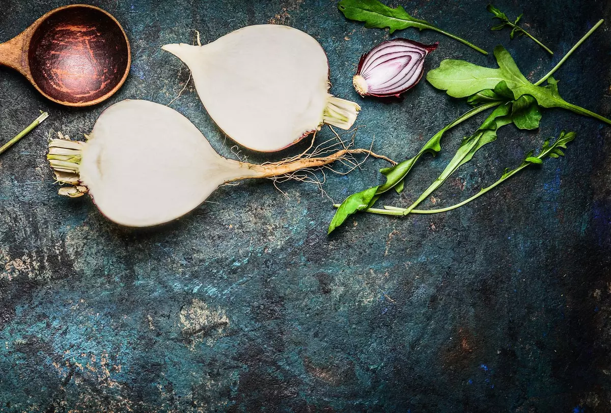 Root vegetables with wooden spoon and fresh ingredients for  healthily cooking.